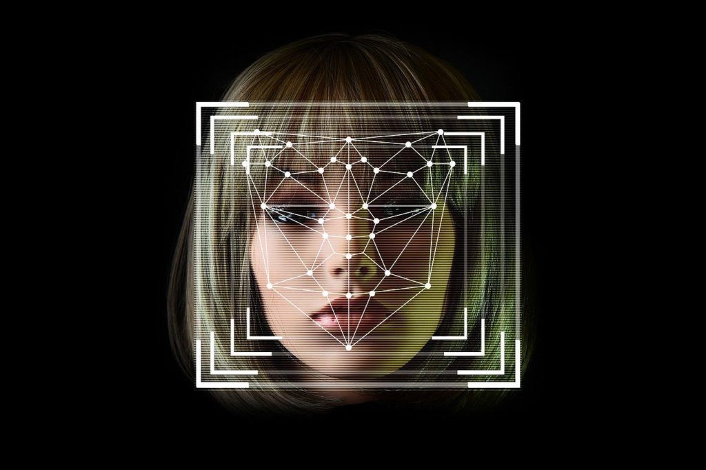 Pontos posicionados em rosto de mulher para leitura de algoritmo: tecnologia e democracia no centro das atenções.